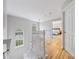 Bright hallway with hardwood floors, white railings, and large windows at 8709 Huntland Ct, Charlotte, NC 28277