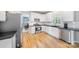 Well-lit kitchen with stainless steel appliances and white cabinets, ready for cooking at 8709 Huntland Ct, Charlotte, NC 28277