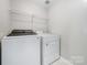 Bright laundry room featuring a washer and dryer with storage at 8709 Huntland Ct, Charlotte, NC 28277