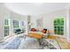 Bright living room featuring wood floors, contemporary furniture, large windows, and a light and airy feel at 8709 Huntland Ct, Charlotte, NC 28277