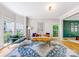 Cozy living room featuring hardwood floors, lots of natural light, and comfortable modern furniture at 8709 Huntland Ct, Charlotte, NC 28277