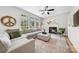 Cozy living room with large windows, a fireplace, and comfortable seating for relaxation at 8709 Huntland Ct, Charlotte, NC 28277