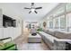 Bright, open living room with a sectional sofa, large windows, and easy access to the kitchen at 8709 Huntland Ct, Charlotte, NC 28277