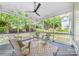 A screened porch with a ceiling fan and outdoor grill at 8709 Huntland Ct, Charlotte, NC 28277