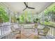 Screened-in porch featuring outdoor seating and a ceiling fan at 8709 Huntland Ct, Charlotte, NC 28277