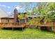 Inviting backyard with a spacious wooden deck, complemented by lush green lawn and mature trees at 9013 St Croix Ln, Charlotte, NC 28277