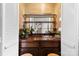 Charming bar area with mirrored shelving, seating, and a beautiful wood countertop at 9013 St Croix Ln, Charlotte, NC 28277