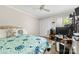 Well-lit bedroom featuring a ceiling fan, closet space, a large bed, and desk area at 9013 St Croix Ln, Charlotte, NC 28277