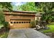 Spacious two-car garage with mature landscaping in the front yard at 9013 St Croix Ln, Charlotte, NC 28277