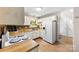 Well-lit kitchen with white appliances, wood countertops, and ample cabinet space at 9013 St Croix Ln, Charlotte, NC 28277