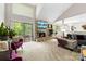 Bright living room featuring vaulted ceilings, a stone fireplace, and sliding glass doors to the deck at 9013 St Croix Ln, Charlotte, NC 28277
