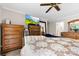 Large main bedroom featuring a ceiling fan, large bed, and multiple wooden dressers at 9013 St Croix Ln, Charlotte, NC 28277