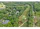 Aerial view of a beautiful home in a golf community surrounded by lush greenery and mature trees at 1001 Berwick Ct, Waxhaw, NC 28173