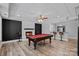 Finished basement featuring a pool table, stone fireplace, and bar area, perfect for entertaining guests at 1001 Berwick Ct, Waxhaw, NC 28173