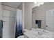 Well-lit bathroom with a shower-tub combo, neutral tile, and bright vanity at 1001 Berwick Ct, Waxhaw, NC 28173