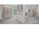 Large walk-in closet with built-in shelving, drawers, and natural light at 1001 Berwick Ct, Waxhaw, NC 28173