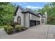 Stunning home exterior boasts a three car garage, brick, and lush landscaping at 1001 Berwick Ct, Waxhaw, NC 28173