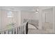 Second floor hallway with ornate wrought iron railings, chandelier, and neutral tones at 1001 Berwick Ct, Waxhaw, NC 28173