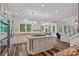 Open-concept kitchen features an island cooktop, stainless appliances, and view of eat-in kitchen at 1001 Berwick Ct, Waxhaw, NC 28173