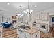 Bright kitchen with granite countertops, stainless appliances, and an island cooktop, open to the living room at 1001 Berwick Ct, Waxhaw, NC 28173