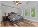 Spacious main bedroom with tray ceilings, neutral paint, hardwood floors and windows for natural light at 1001 Berwick Ct, Waxhaw, NC 28173