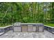 Modern outdoor kitchen featuring a built-in grill, stainless steel appliances, and ample countertop space at 1001 Berwick Ct, Waxhaw, NC 28173
