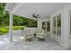 Cozy covered patio with comfortable seating, perfect for relaxing and enjoying the outdoor scenery at 1001 Berwick Ct, Waxhaw, NC 28173