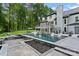 Resort-like backyard includes pristine pool, spa, patio with lounge chairs and an outdoor kitchen at 1001 Berwick Ct, Waxhaw, NC 28173