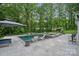 Backyard featuring an in-ground pool, complete with lounge chairs, umbrellas and patio seating areas at 1001 Berwick Ct, Waxhaw, NC 28173