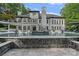 Luxury home featuring an inviting in-ground pool, complete with a beautiful stone waterfall and lounging area at 1001 Berwick Ct, Waxhaw, NC 28173