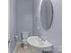This half bathroom features a modern toilet, sink, and a stylish oval mirror at 112 St Vincent Pl, Mount Holly, NC 28120