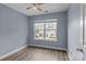 This well-lit bedroom features a ceiling fan, hardwood floors, and a view of the outdoors at 112 St Vincent Pl, Mount Holly, NC 28120