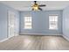 This bright bedroom features hardwood floors, two windows, and a ceiling fan at 112 St Vincent Pl, Mount Holly, NC 28120