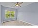 This cozy bedroom features a ceiling fan, hardwood floors, and large window at 112 St Vincent Pl, Mount Holly, NC 28120