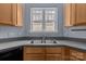 Functional kitchen space with ample cabinet storage, a double sink, and a bright window at 112 St Vincent Pl, Mount Holly, NC 28120