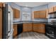 Well-equipped kitchen featuring modern appliances, wood cabinetry, and a functional layout at 112 St Vincent Pl, Mount Holly, NC 28120
