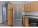 Kitchen featuring a stainless steel refrigerator, wood cabinets, and ample counter space at 112 St Vincent Pl, Mount Holly, NC 28120