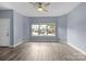A spacious living room features hard surface floors, a ceiling fan, and plenty of natural light at 112 St Vincent Pl, Mount Holly, NC 28120