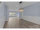 Bright living room with stylish lighting, hard surface floors, and a view to the outside at 112 St Vincent Pl, Mount Holly, NC 28120