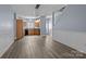 Spacious living room seamlessly connecting to the kitchen with matching hard surface floors at 112 St Vincent Pl, Mount Holly, NC 28120