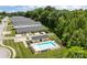 Aerial view of the pool, pool house, and surrounding townhome community at 112 St Vincent Pl, Mount Holly, NC 28120