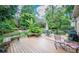 Backyard featuring a wooden deck, and an umbrella-covered table with chairs at 11724 Brambleton Ct, Charlotte, NC 28277