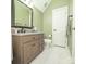 Bathroom with light green walls, granite countertop, modern fixtures and white tile flooring at 11724 Brambleton Ct, Charlotte, NC 28277