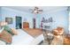 Comfortable bedroom features a ceiling fan, wood floors, and an adjacent desk area at 11724 Brambleton Ct, Charlotte, NC 28277