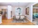 Charming dining area features a wooden table and white chairs, next to the kitchen and with natural light at 11724 Brambleton Ct, Charlotte, NC 28277