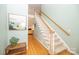 Open entryway featuring hardwood floors, a carpeted staircase, and stylish decor at 11724 Brambleton Ct, Charlotte, NC 28277