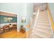 Welcoming entryway with a carpeted staircase, hardwood floors, and a view into the dining room at 11724 Brambleton Ct, Charlotte, NC 28277