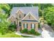Charming brick home with well-maintained landscaping, mature trees, and a paved driveway leading to the garage at 11724 Brambleton Ct, Charlotte, NC 28277