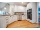 Charming kitchen features white cabinets, stainless steel appliances and a built-in microwave for convenience at 11724 Brambleton Ct, Charlotte, NC 28277