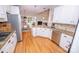 Spacious kitchen with an island, granite countertops, stainless steel appliances and hardwood floors at 11724 Brambleton Ct, Charlotte, NC 28277